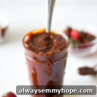 Side shot of BBQ sauce in a glass jar.