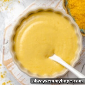 Overhead view of beer cheese pretzel dip in bowl with spoon