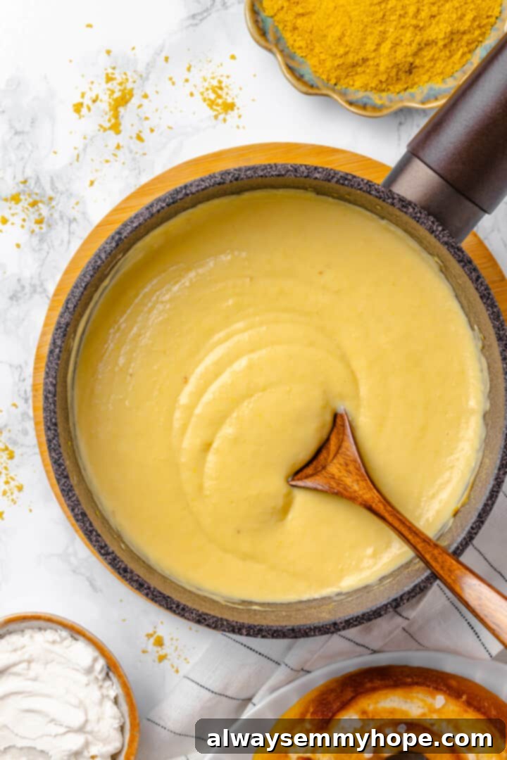 Overhead view of the finished, smooth beer cheese pretzel dip in a saucepan