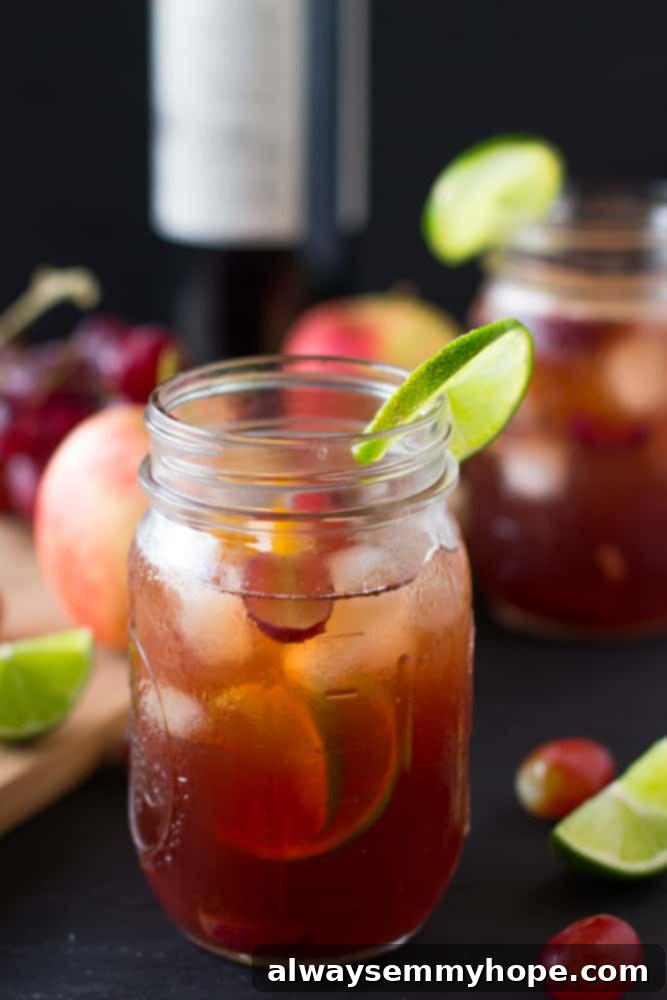 A close-up view of Rosé Sangria in a mason jar, showcasing the colourful medley of fresh fruit slices infused within the pink wine.