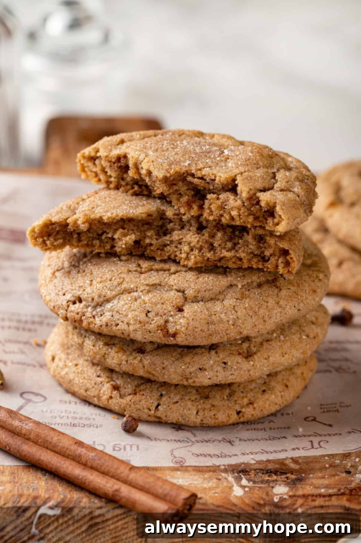 Stack of chai sugar cookies on wooden board with cinnamon stick, conveying warmth and comfort