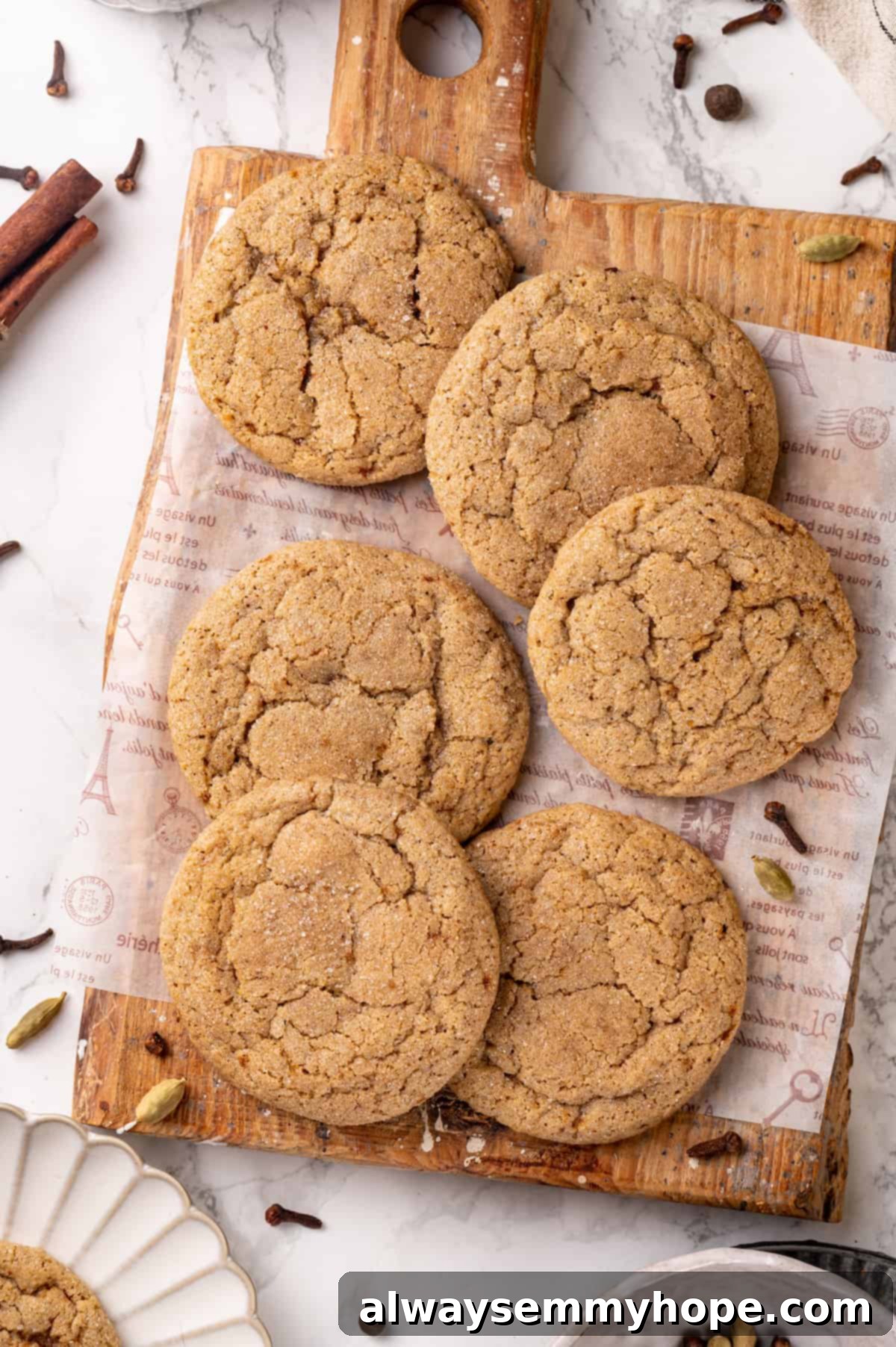 Overhead view of beautiful vegan chai sugar cookies scattered on a wooden board