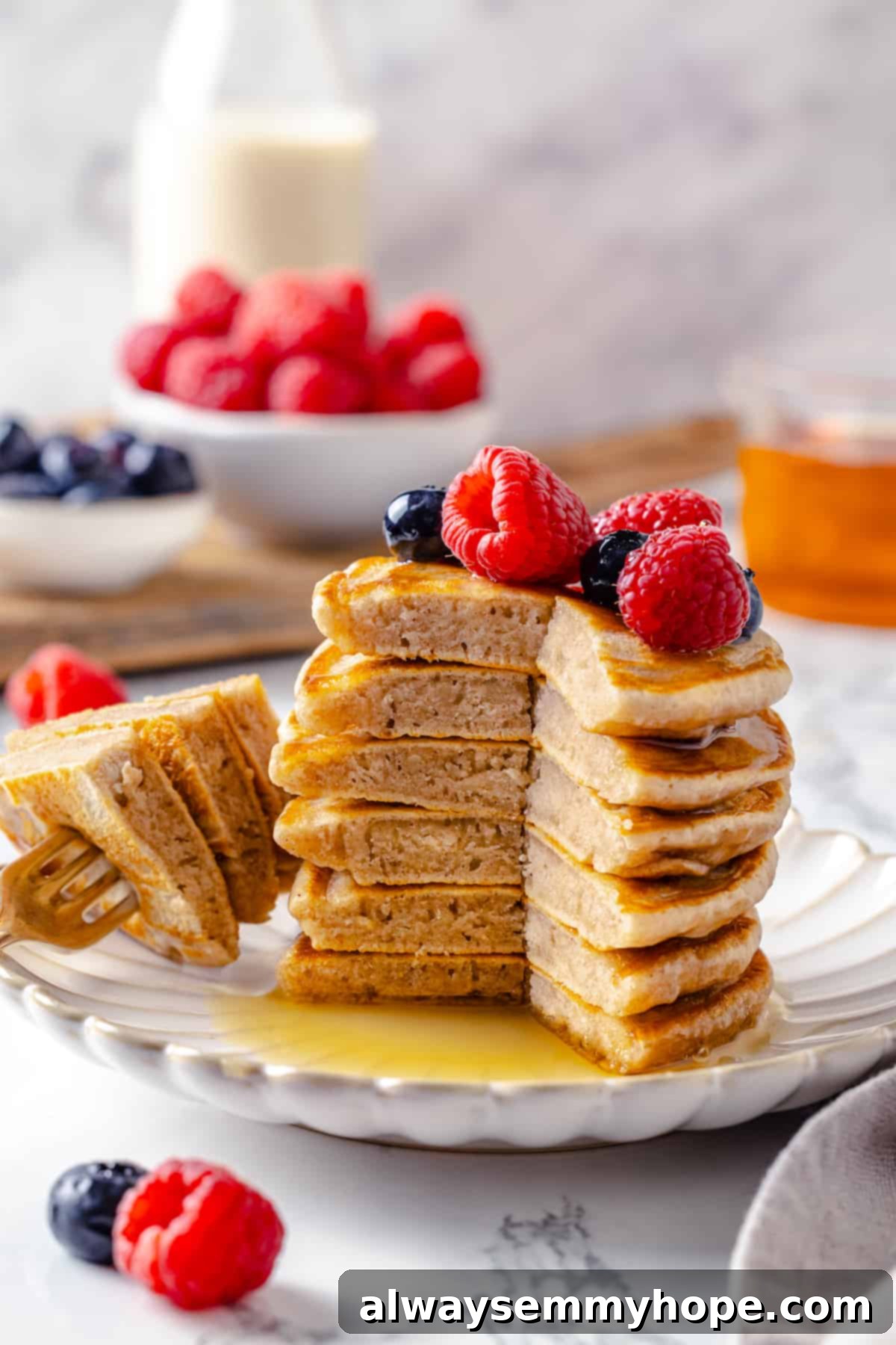 Stack of fluffy silver dollar pancakes on plate
