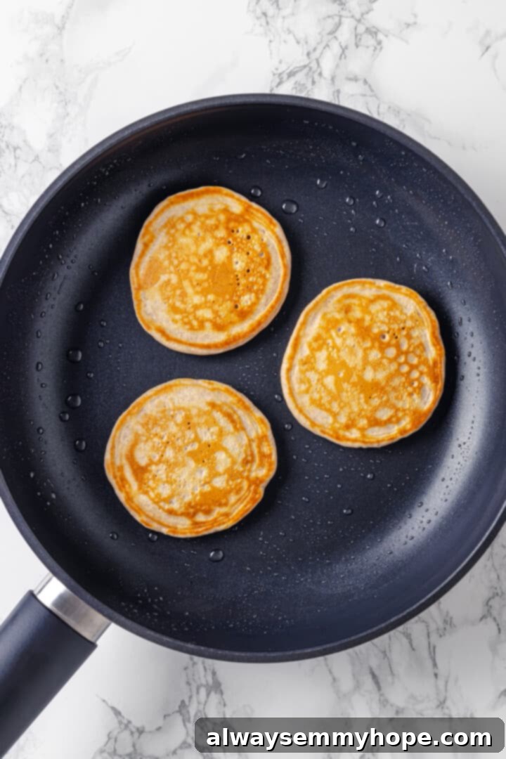 Overhead view of silver dollar pancakes in skillet