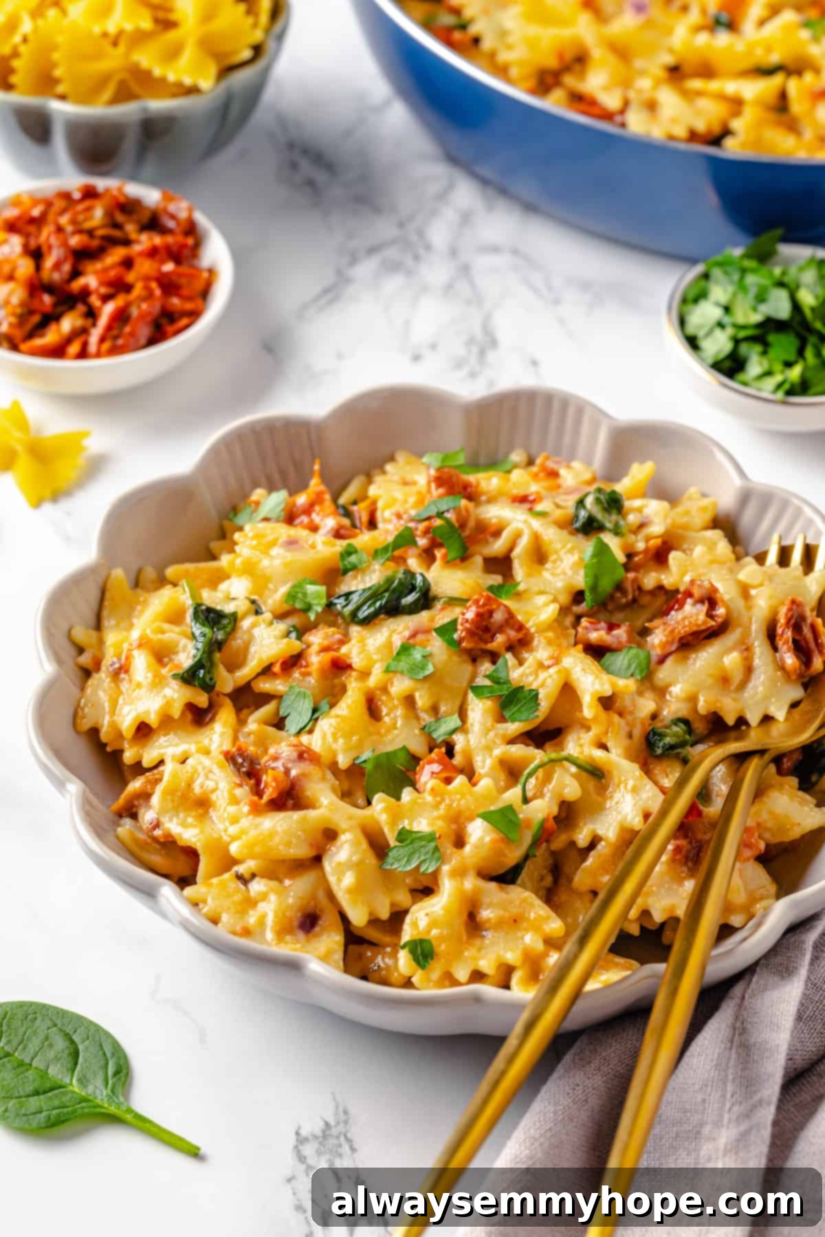 Creamy sun-dried tomato pasta, a delicious vegan dish. Close-up of a bowl of creamy sun-dried tomato pasta with spinach, highlighting the rich sauce and texture.