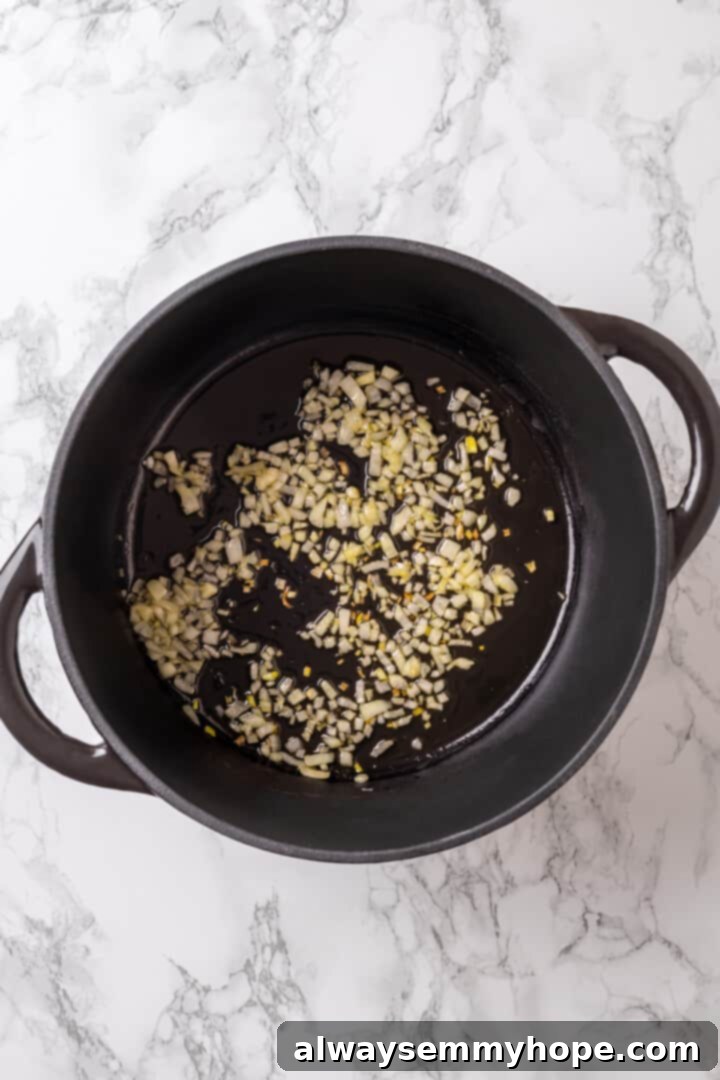 Satisfying cabbage roll soup is a filling meal in a bowl! Skip all the work and enjoy your cabbage rolls in the form of a hearty soup recipe. Overhead view of diced onions sizzling and caramelizing in olive oil within a large soup pot.