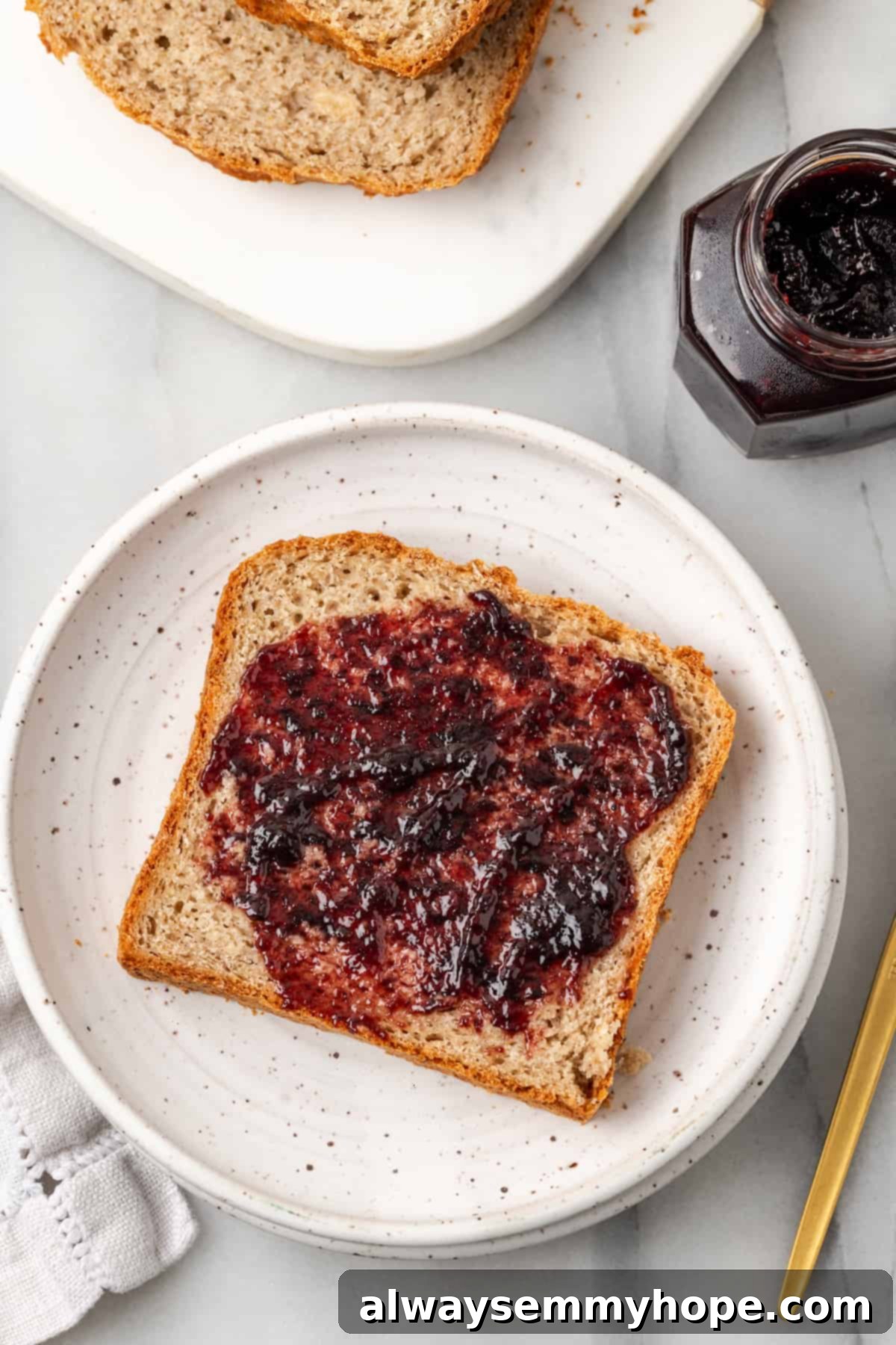 Overhead view of gluten-free sandwich bread spread with jam