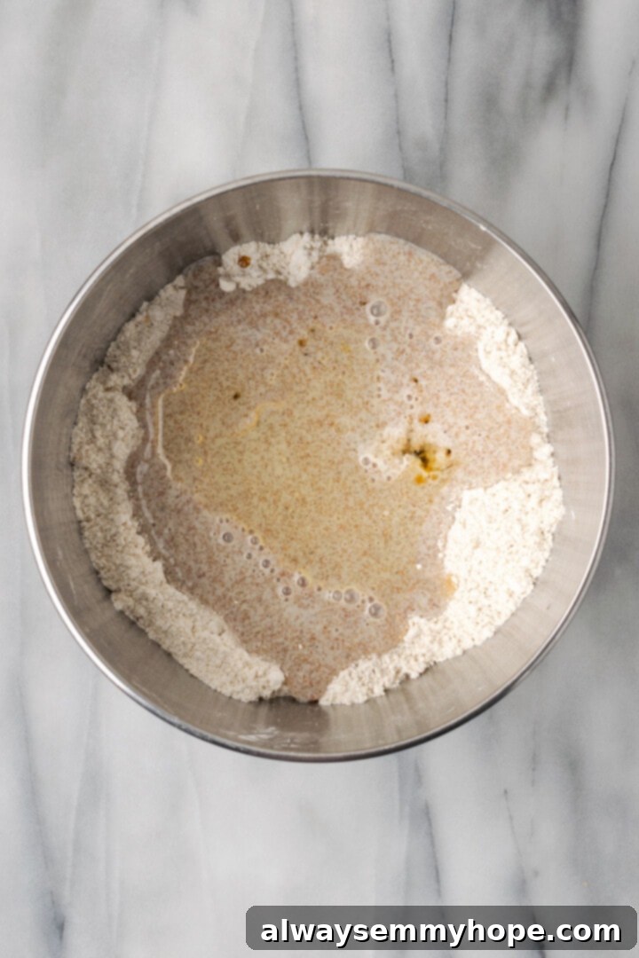 Overhead view of liquid ingredients added to dry ingredients for bread
