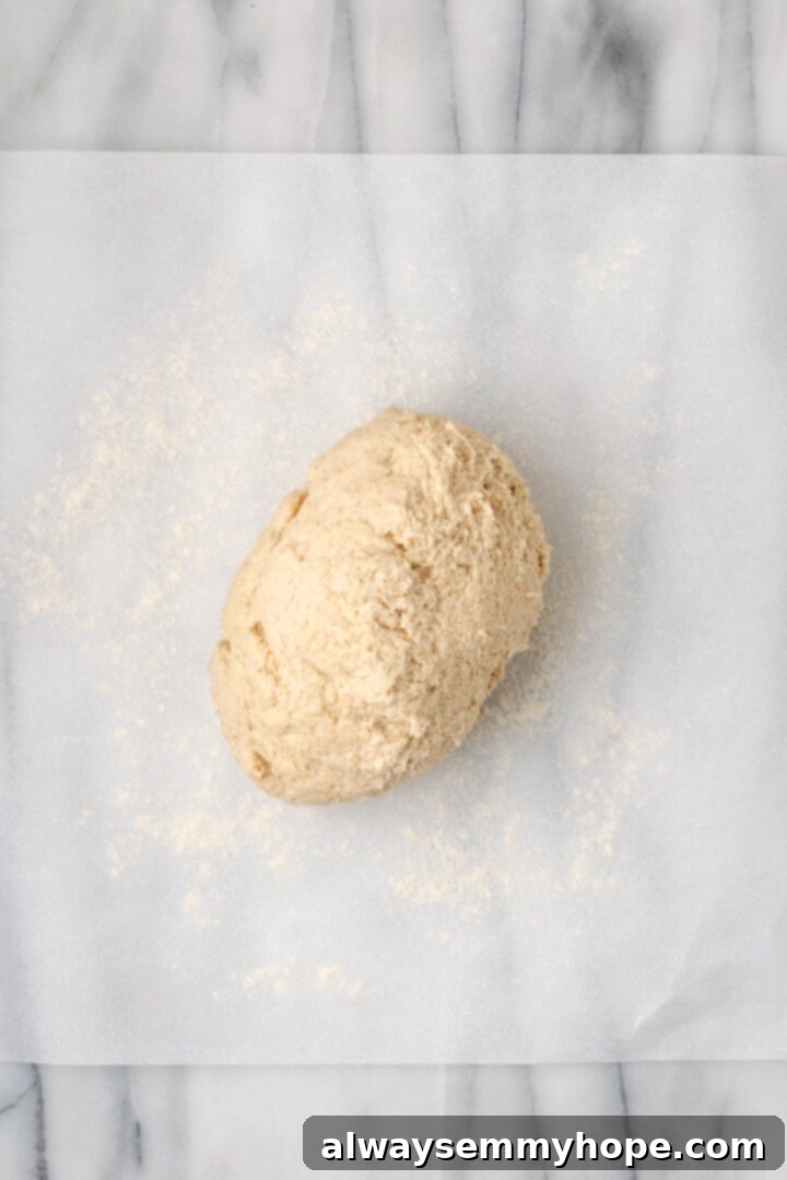 Overhead view of gluten-free dough turned out onto parchment paper