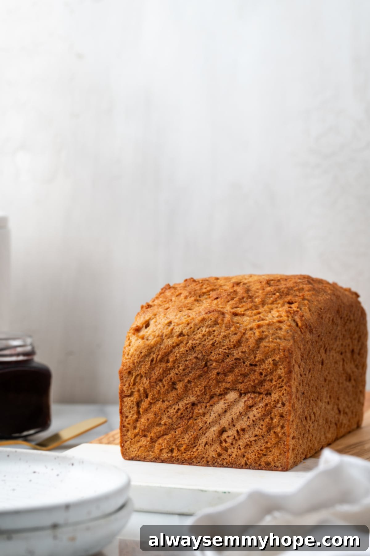 Whole loaf of gluten-free sandwich bread on wood board