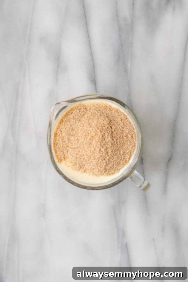 Overhead view of psyllium and soy milk in liquid measuring cup