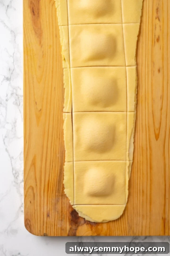 Butternut squash ravioli is fun to make at home and the results are delicious. Tender pasta pockets filled with creamy, caramelized squash! Ravioli on board before separating