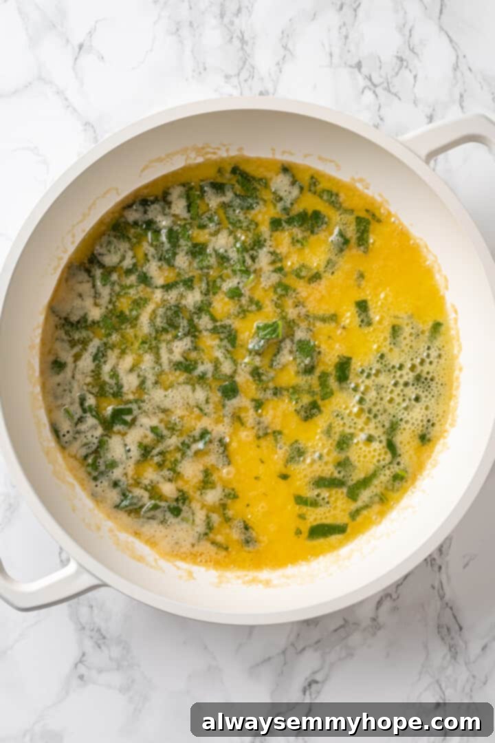 Butternut squash ravioli is fun to make at home and the results are delicious. Tender pasta pockets filled with creamy, caramelized squash! Brown butter sauce in pan