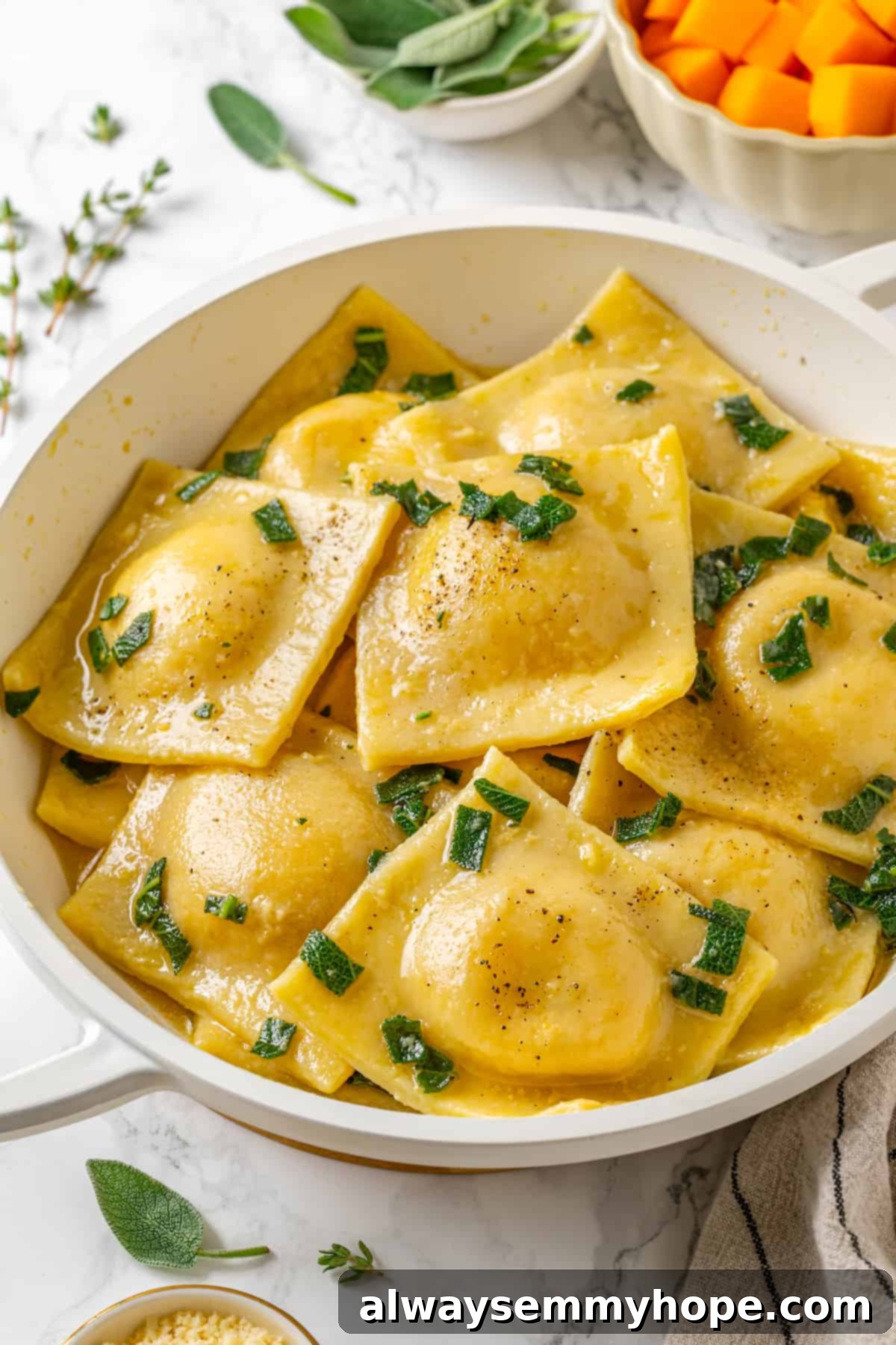 Butternut squash ravioli is fun to make at home and the results are delicious. Tender pasta pockets filled with creamy, caramelized squash! Butternut squash ravioli in pan with sage and brown butter