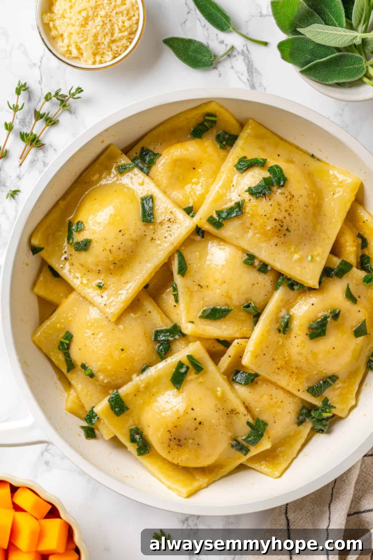Butternut squash ravioli is fun to make at home and the results are delicious. Tender pasta pockets filled with creamy, caramelized squash! Overhead view of butternut squash ravioli in pan