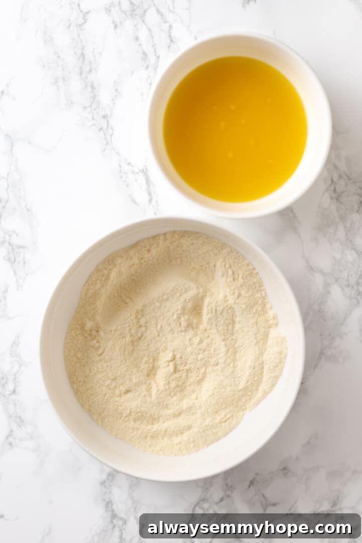 Butternut squash ravioli is fun to make at home and the results are delicious. Tender pasta pockets filled with creamy, caramelized squash! Overhead view of liquid and dry ingredients in bowls for pasta