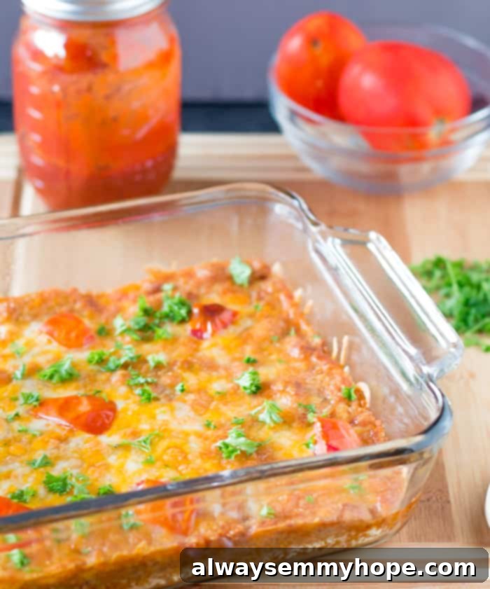 A bubbling cheesy quinoa casserole nestled in a clear glass baking dish, fresh from the oven, showcasing its warm and inviting textures.