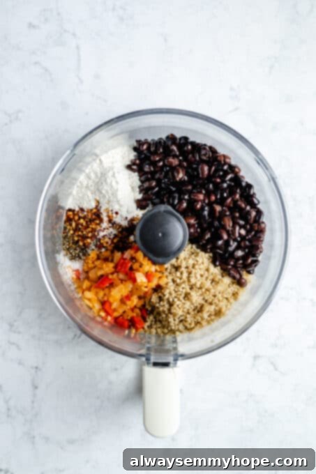 Black bean burgers are made with cooked quinoa, sautéed onions, and smoky strawberry BBQ sauce! Veggie burgers have never tasted this good! Black beans and quinoa with seasoning in a food processor.