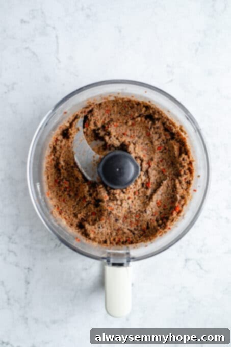 Black bean burgers are made with cooked quinoa, sautéed onions, and smoky strawberry BBQ sauce! Veggie burgers have never tasted this good! Blended black bean burger mixture.