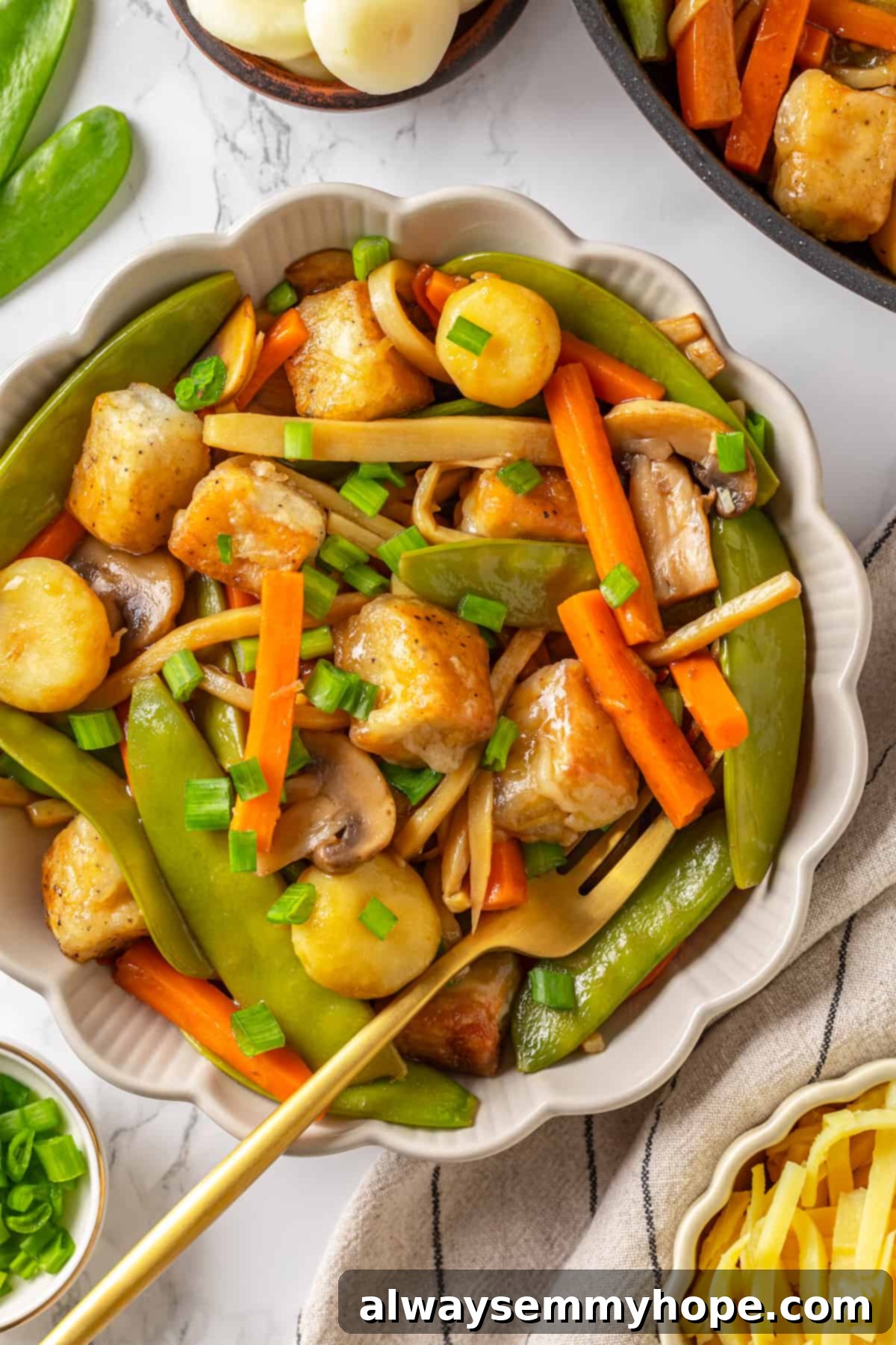 Overhead view of moo goo gai pan ingredients in bowl, showcasing colorful vegetables and tofu