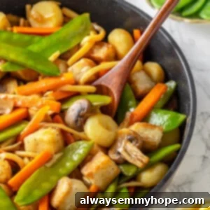 Pan of moo goo gai pan with wooden spoon