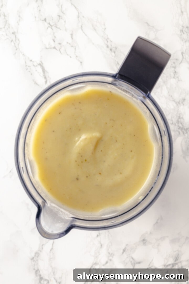 Blending the vichyssoise to a smooth consistency The cooked soup mixture being transferred into a high-speed blender for puréeing