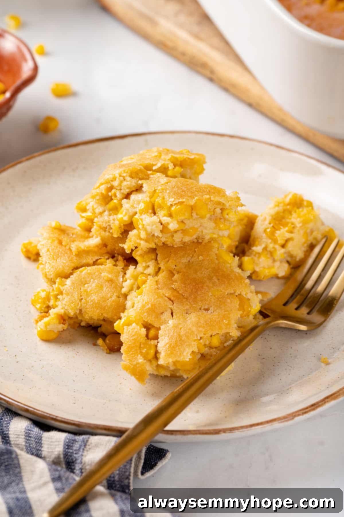 Corn soufflé is a classic holiday side dish, but easy enough to make for a weeknight! You’ll love the sweet flavour and creamy texture. Vegan corn soufflé on a plate with a fork, ready to be enjoyed