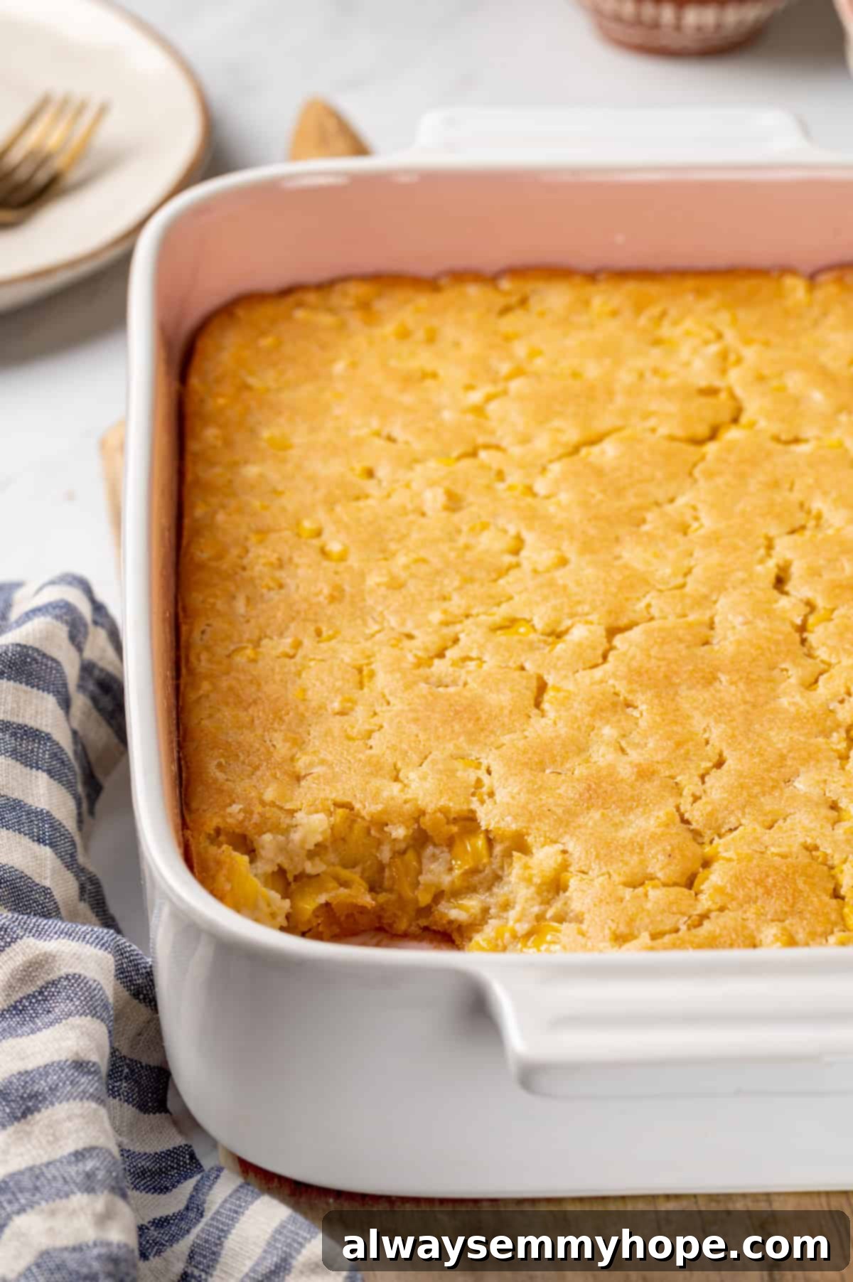 Corn soufflé is a classic holiday side dish, but easy enough to make for a weeknight! You’ll love the sweet flavour and creamy texture. Fluffy vegan corn soufflé in a baking dish with a portion removed, revealing its light texture