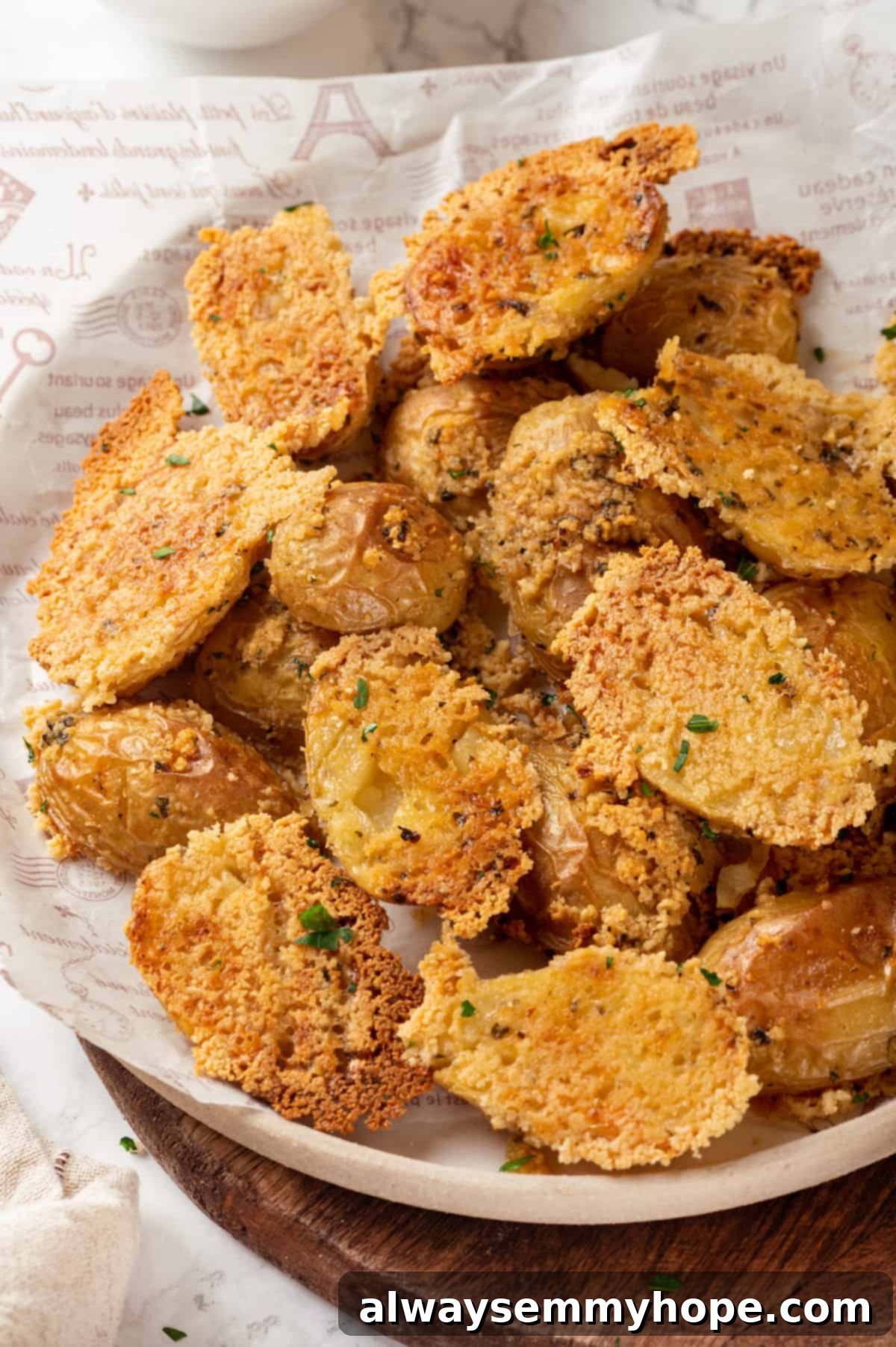 Crispy vegan Parmesan crusted potatoes: fluffy inside, cheesy outside, your new favorite side! Plate of crispy vegan Parmesan-crusted potatoes ready to serve