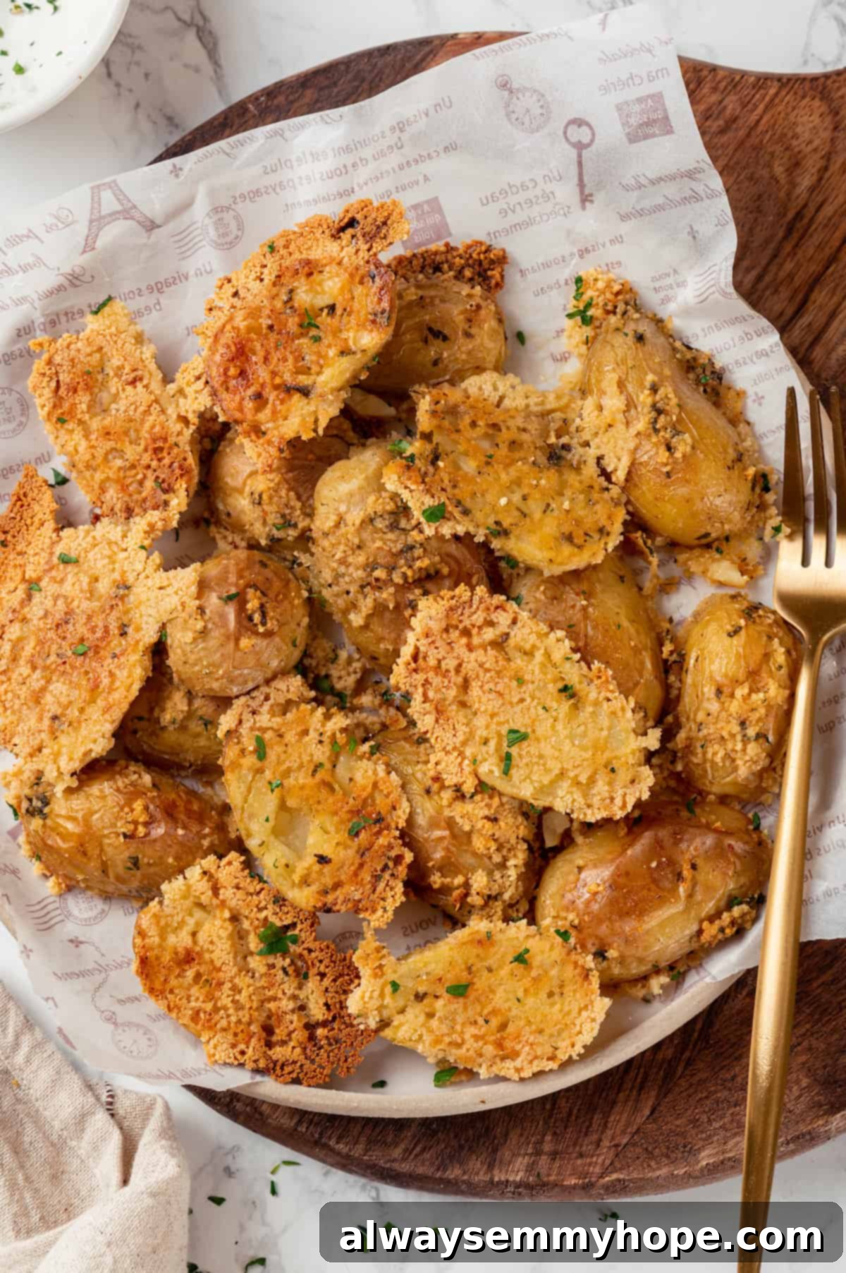 A portion of delicious vegan Parmesan crusted potatoes on a white plate. Vegan Parmesan-crusted potatoes served on a white plate