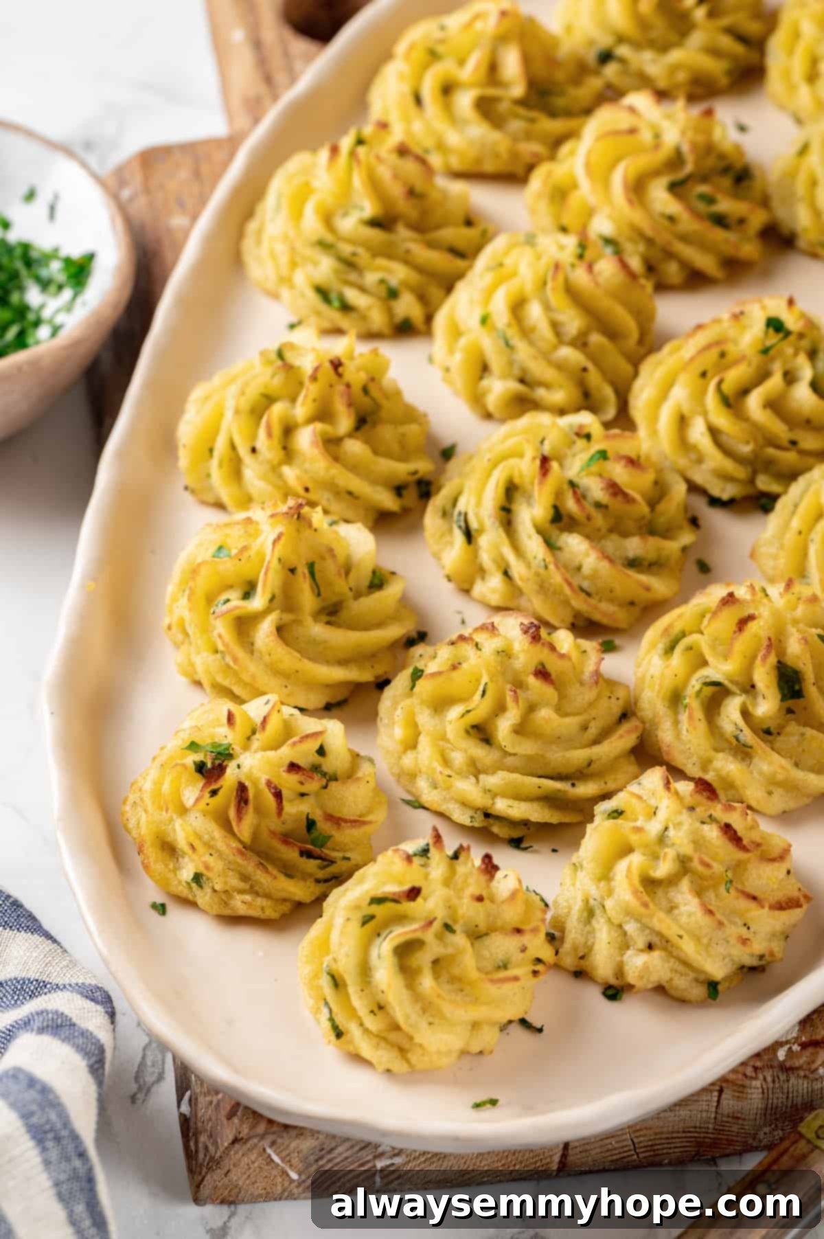 Golden brown vegan duchess potatoes baked on a tray