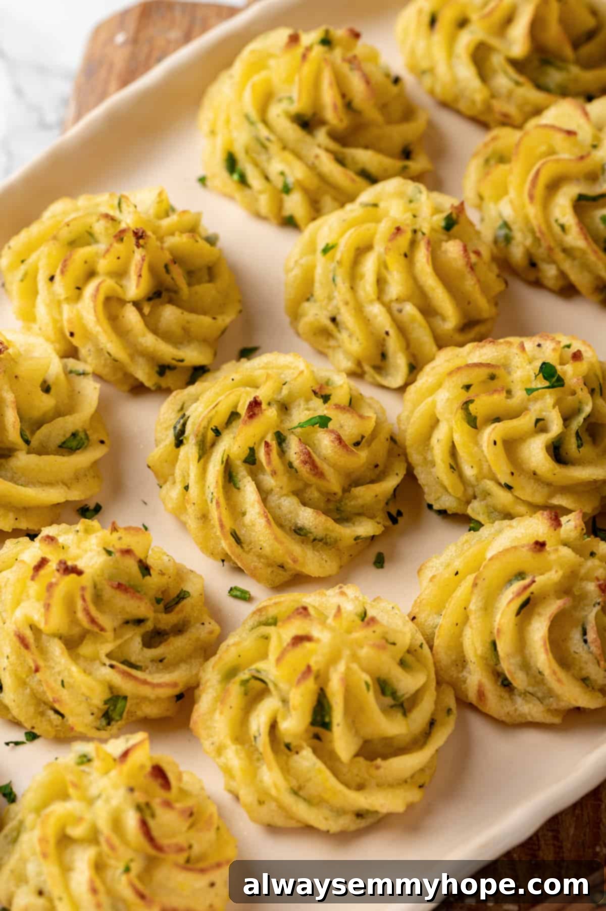 Platter of golden, crispy vegan duchess potatoes