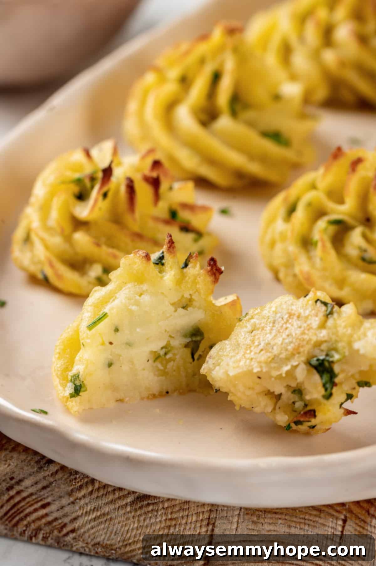 Halved duchess potato on a plate to reveal its creamy interior