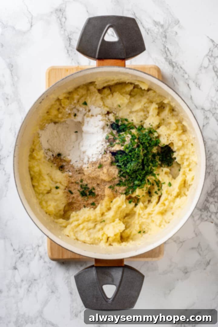 Cornstarch, fresh herbs, and savory seasonings added to mashed potatoes in a pot