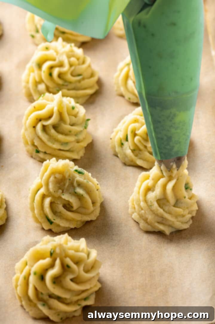 Piping elegant swirls of duchess potatoes onto a prepared baking pan
