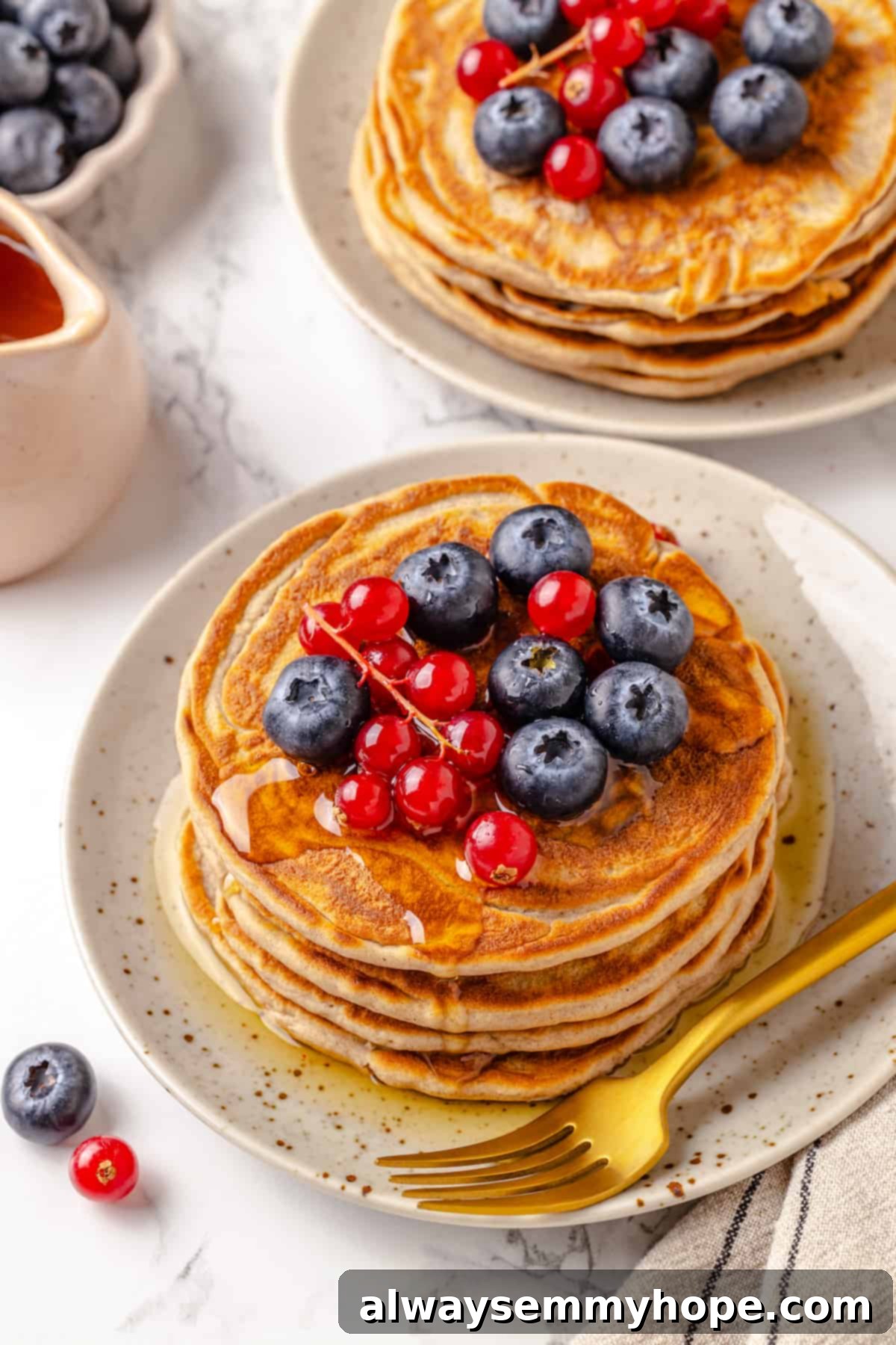 Plates of protein pancakes with berries on top
