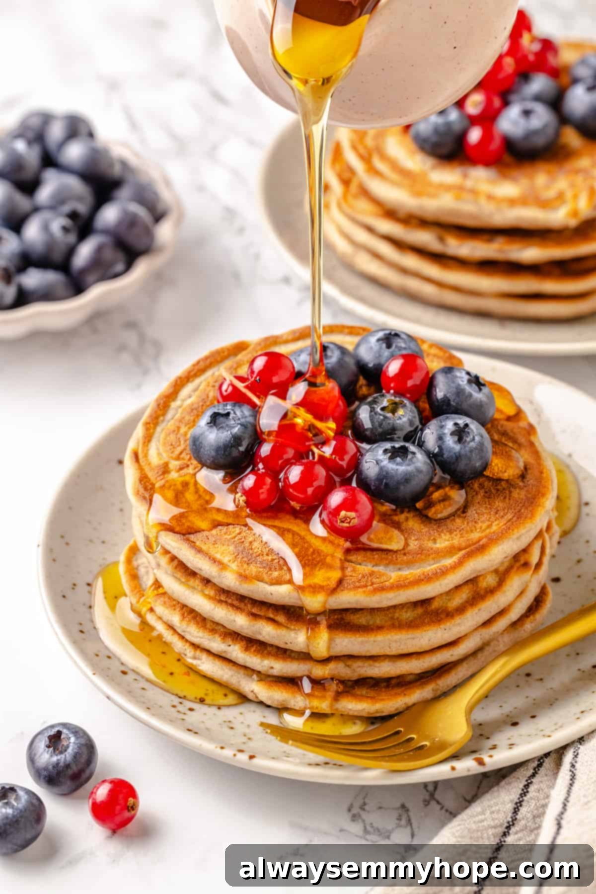 Pouring maple syrup over protein pancakes