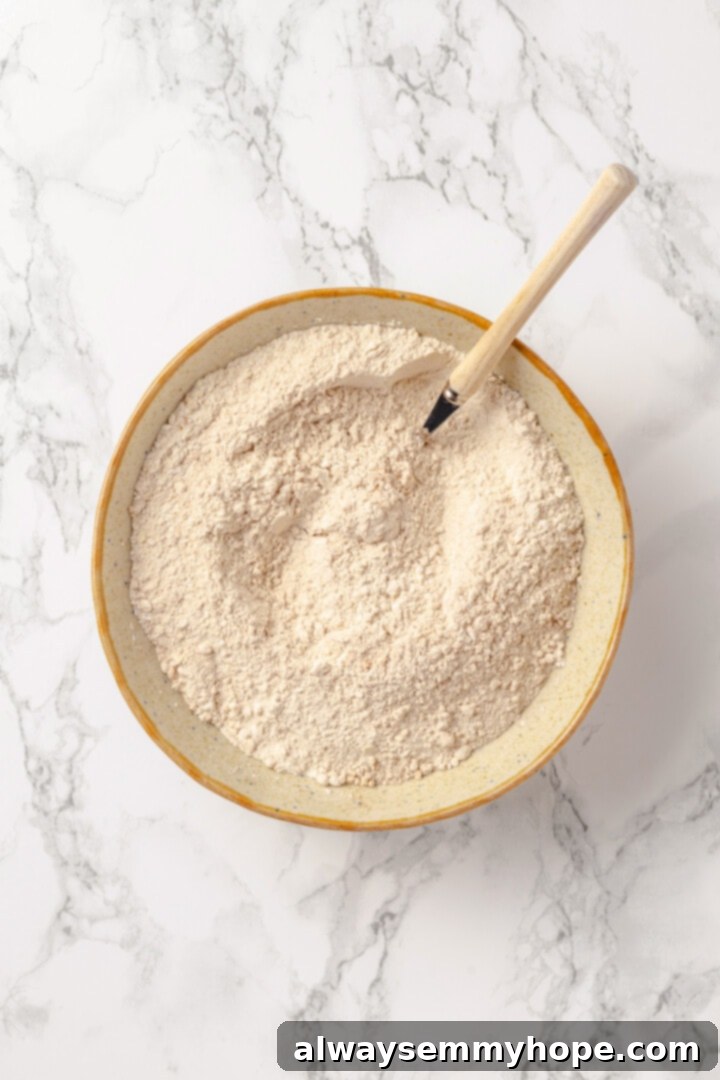 Overhead view of dry ingredients for protein pancakes in mixing bowl