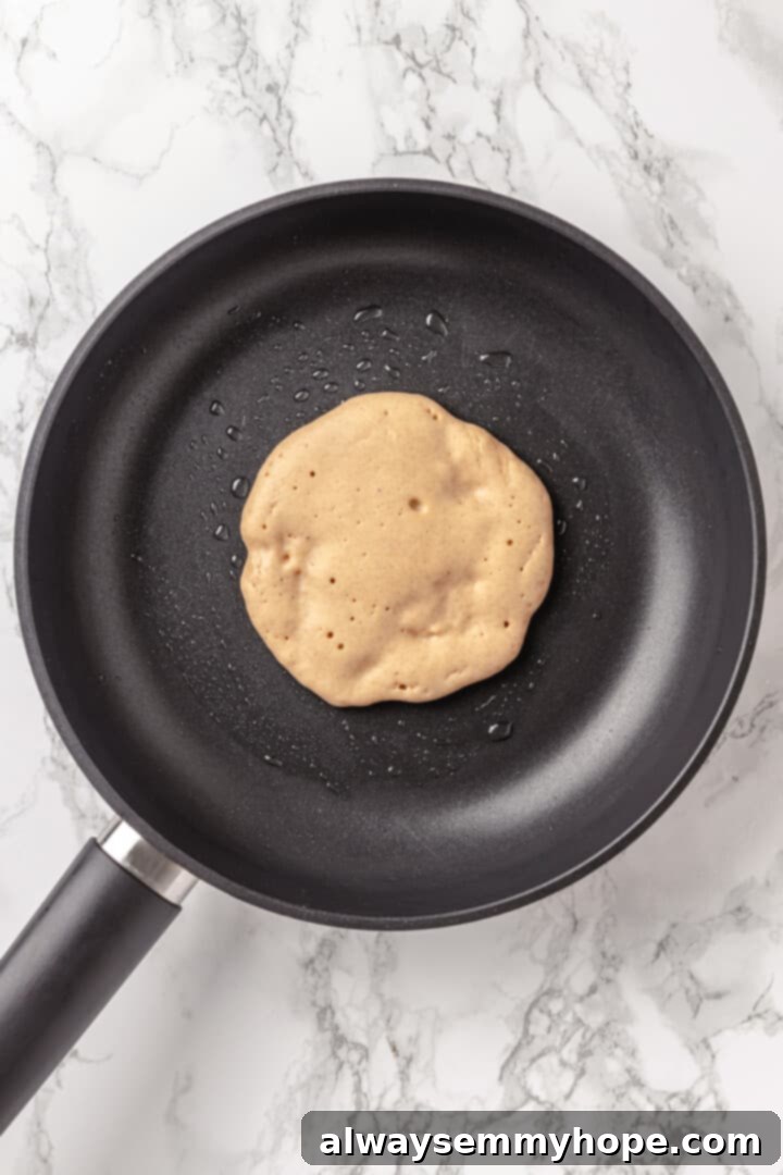 Overhead view of pancake in skillet before flipping