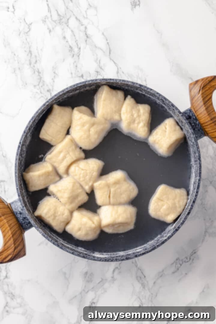 Homemade vegan pretzel bites are the snackable sibling to regular soft pretzels! They're perfect for game day parties and easy to make too. Pretzel bites simmering in a pot of boiling water and baking soda, creating their characteristic chewy crust.