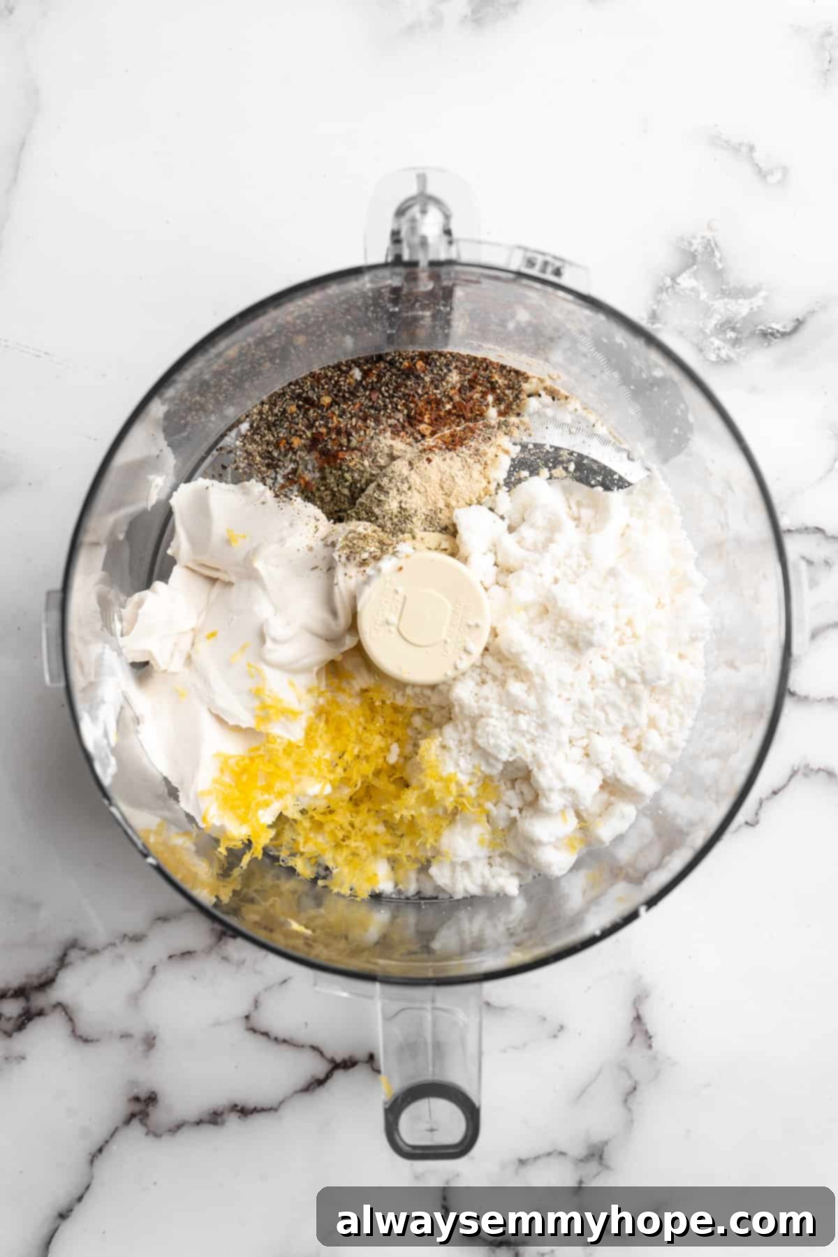 Overhead view of all vegan whipped feta ingredients placed into a food processor, ready for blending.