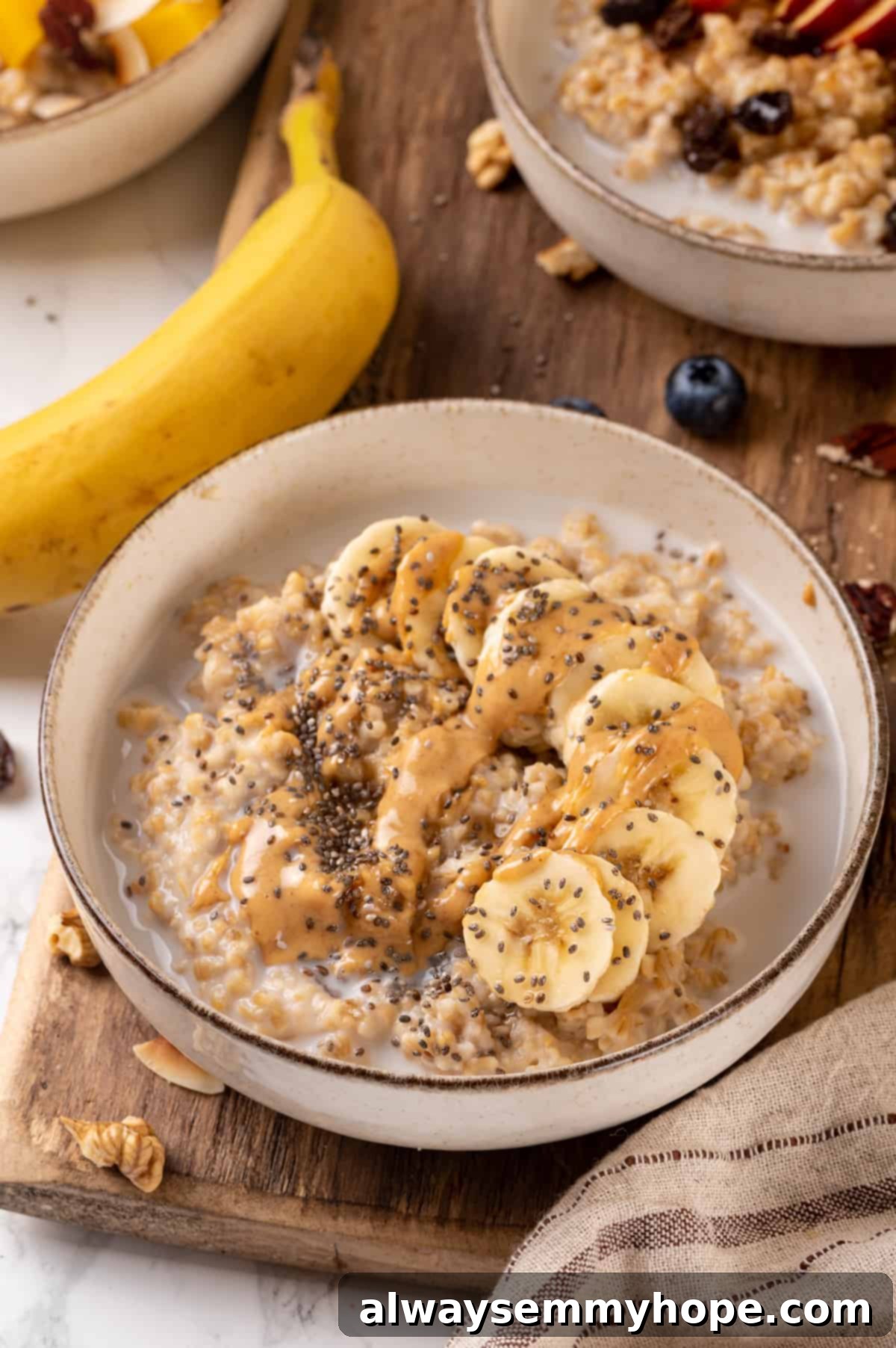 This Instant Pot steel-cut oats recipe is the easiest way to make hearty and creamy oatmeal for breakfast. Simple, hands-off recipe! Bowl of Instant Pot steel-cut oats topped with banana, peanut butter, and chia seeds, ready to be enjoyed