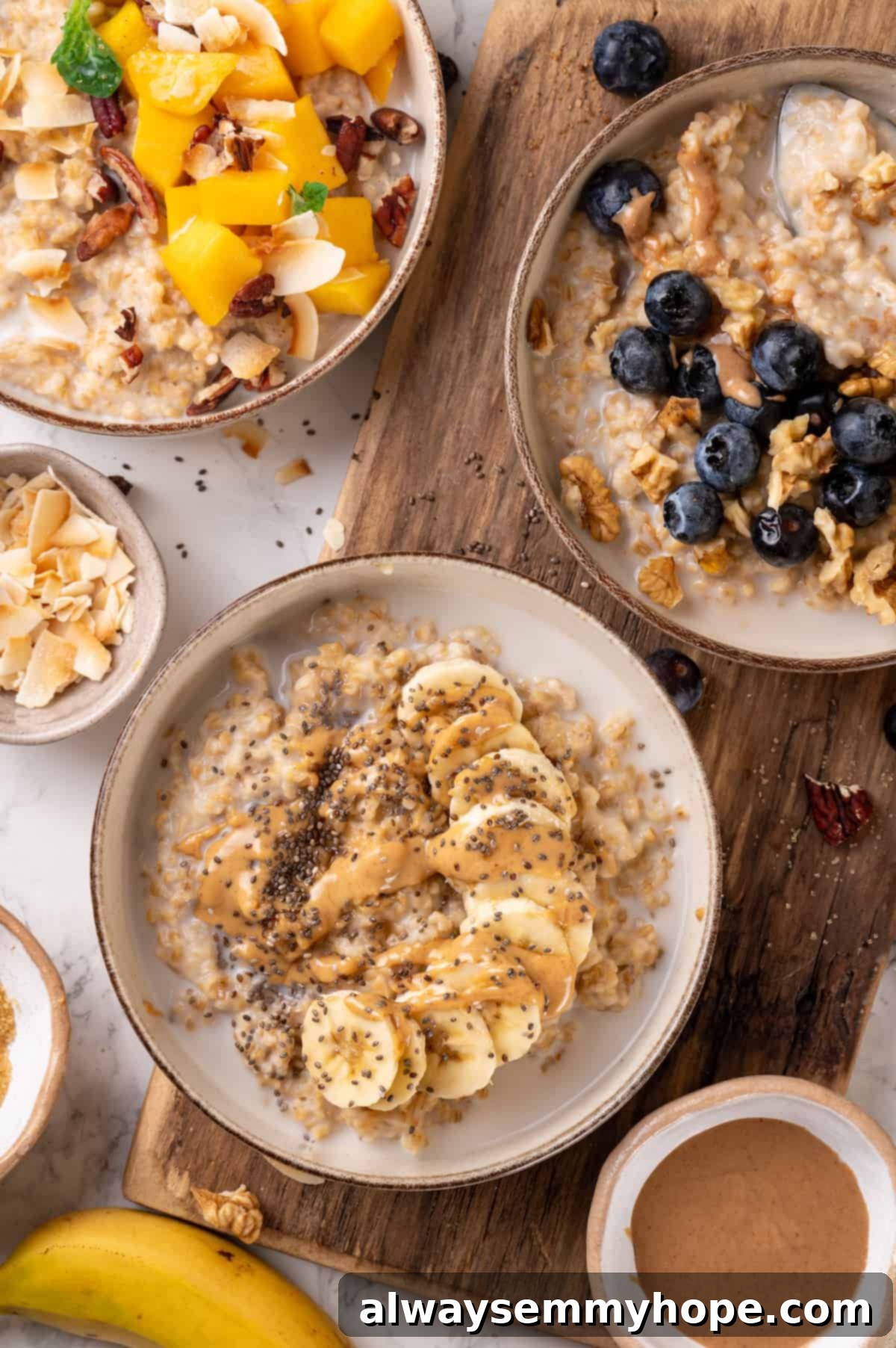 This Instant Pot steel-cut oats recipe is the easiest way to make hearty and creamy oatmeal for breakfast. Simple, hands-off recipe! Overhead view of 3 bowls of Instant Pot steel-cut oats, each with different toppings, ready to be served