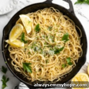 Bright Lemon Pasta 2 Overhead view of lemon pasta in skillet with lemon wedges and parsley for garnish