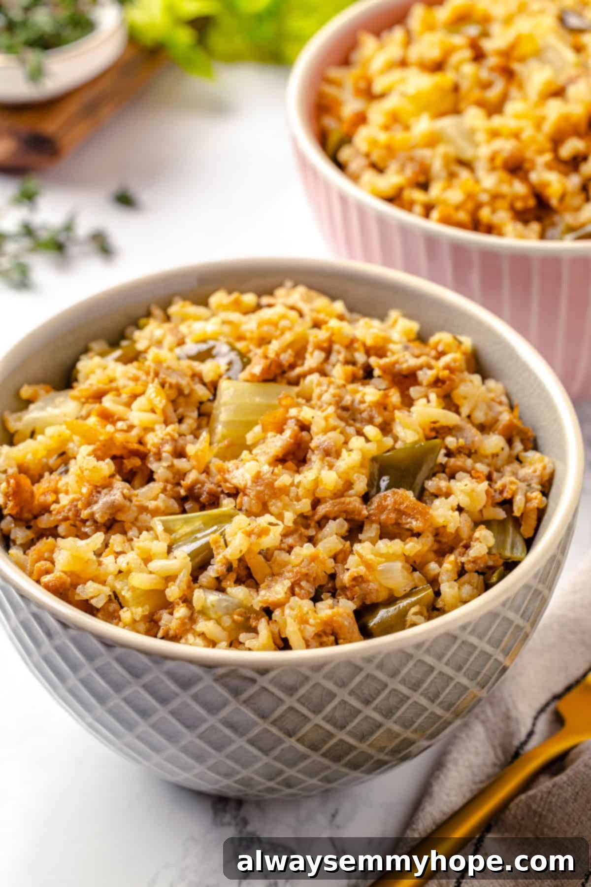 Two generous bowls of vegan dirty rice, garnished with fresh herbs, ready for serving.