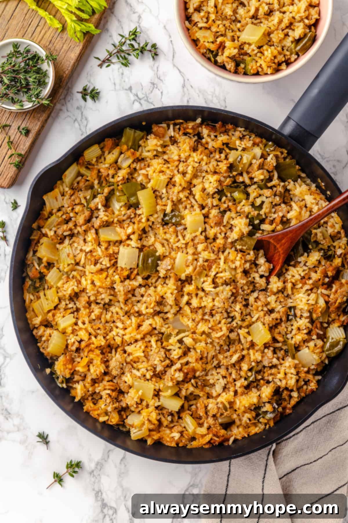 Overhead shot of a large skillet filled with freshly cooked vegan dirty rice, steam gently rising.