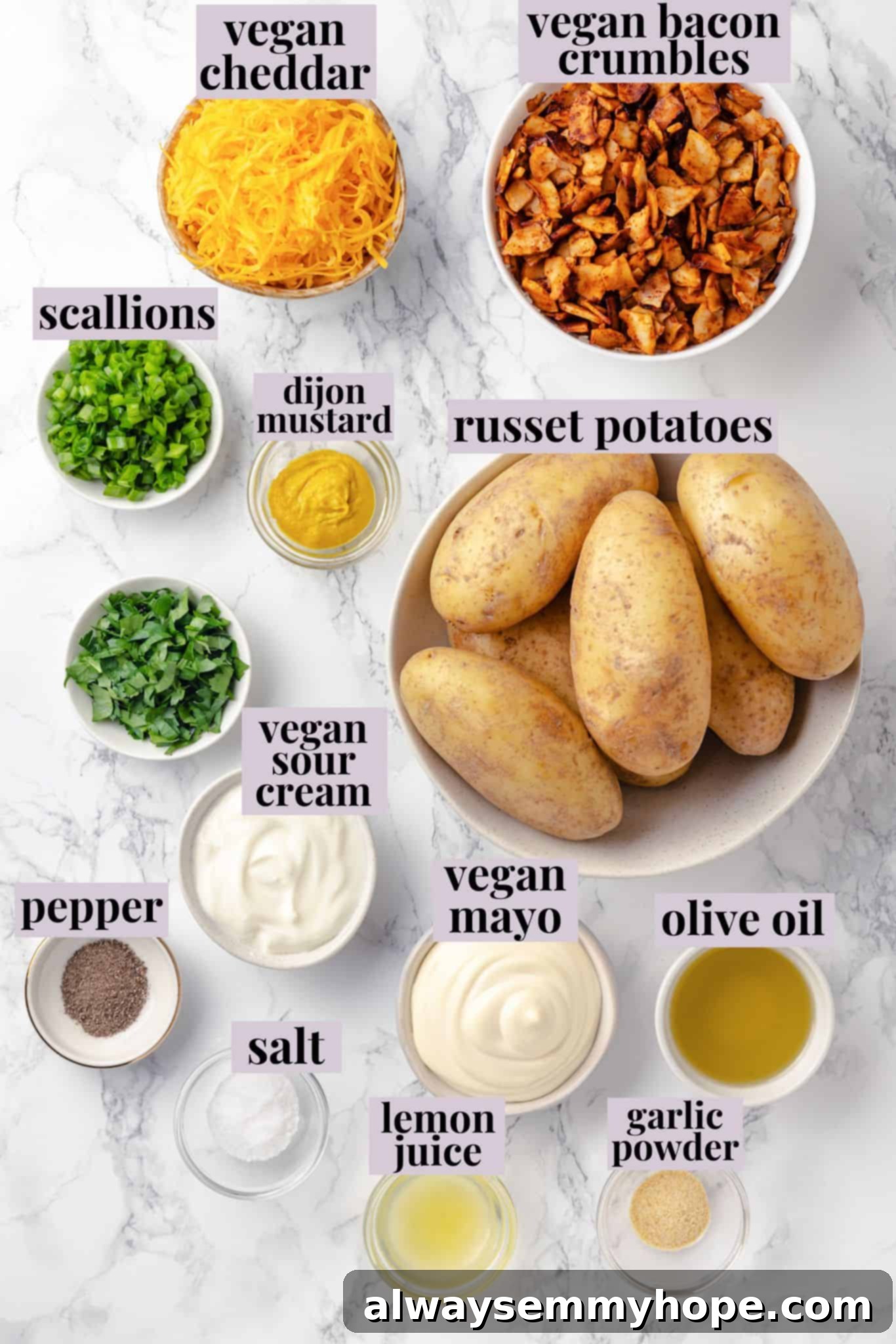 An overhead shot showcasing all the fresh ingredients laid out on a wooden board, ready to be prepared for the vegan loaded potato salad, including whole russet potatoes, herbs, vegan cheese, and vegan bacon.