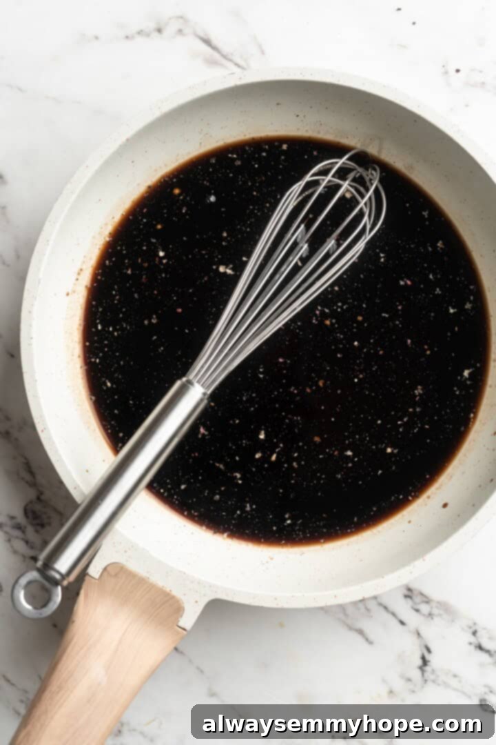 Balsamic glaze ingredients being whisked in a pan on the stovetop, starting the reduction process.