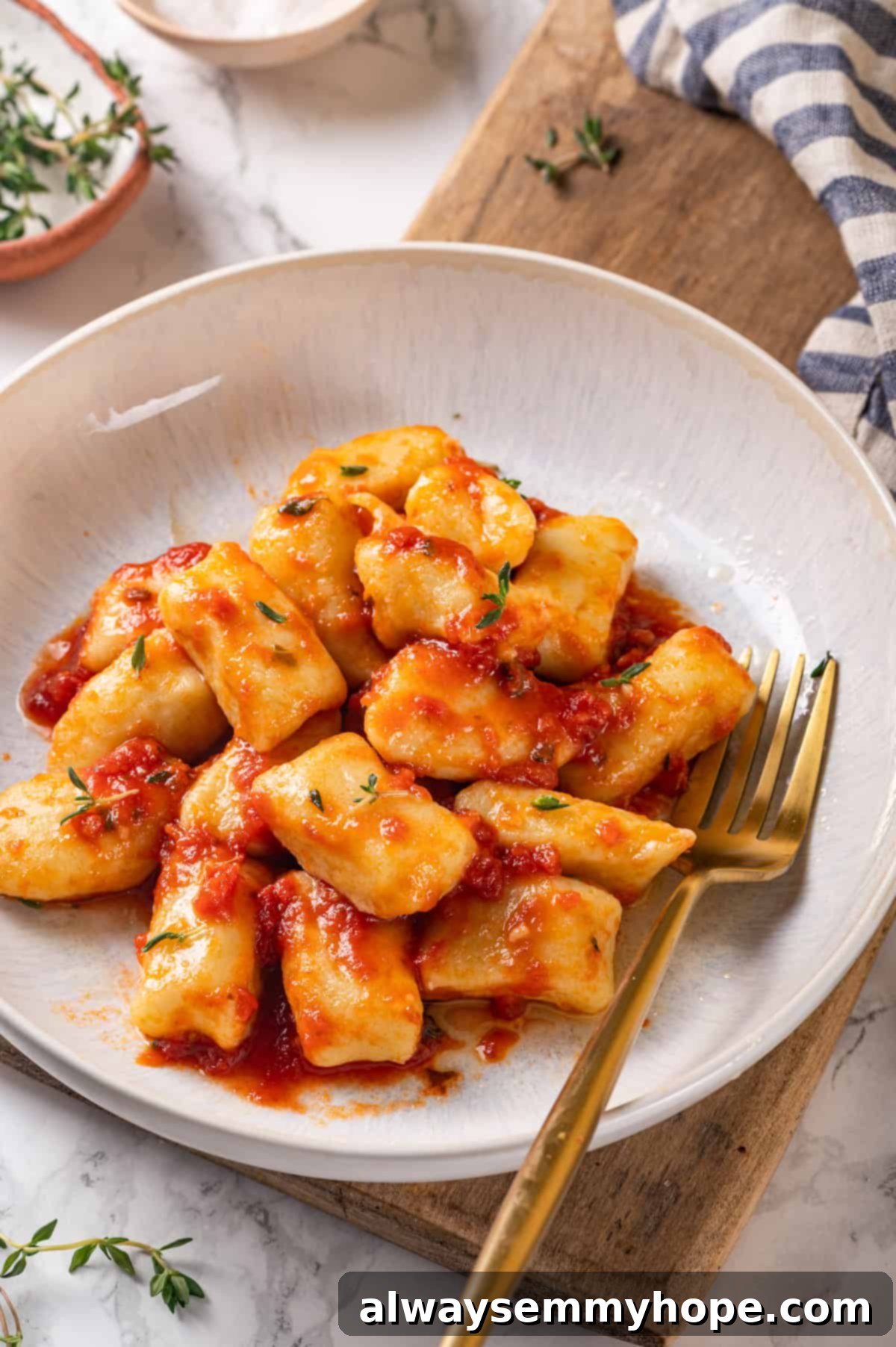 Top-down view of gnocchi in bowl with tomato sauce