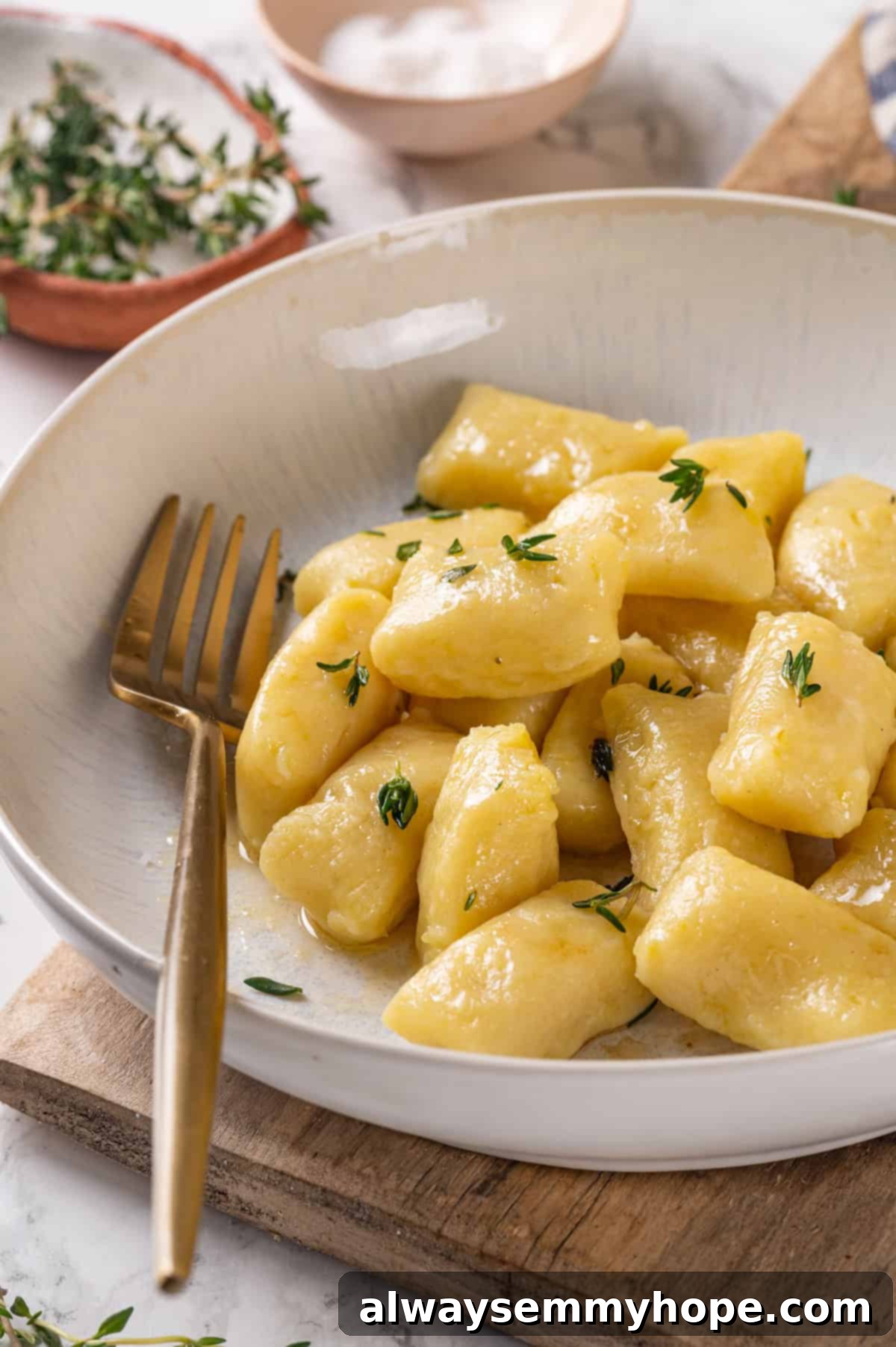 Bowl of gnocchi tossed with butter and thyme